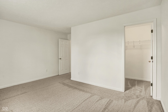 7156 Chemistry Ct, Indianapolis, IN 46239 - unfurnished bedroom with carpet floors, a walk in closet, baseboards, and a closet