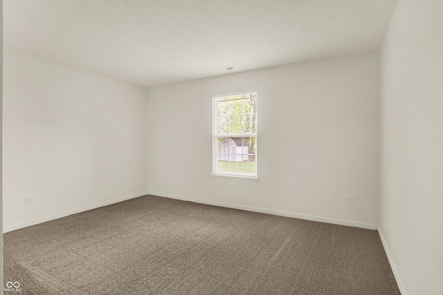 7156 Chemistry Ct, Indianapolis, IN 46239 - spare room featuring carpet floors, baseboards, and a textured ceiling