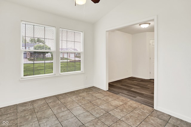 7156 Chemistry Ct, Indianapolis, IN 46239 - unfurnished room with healthy amount of natural light, ceiling fan, lofted ceiling, baseboards, and light tile patterned flooring