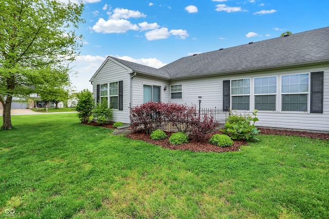 7156 Chemistry Ct, Indianapolis, IN 46239 - view of side of home featuring a lawn and roof with shingles