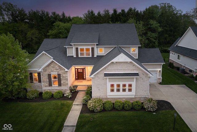 14003 Grannan Ln, Carmel, IN 46074 - view of front of house with concrete driveway, a yard, a garage, and stone siding