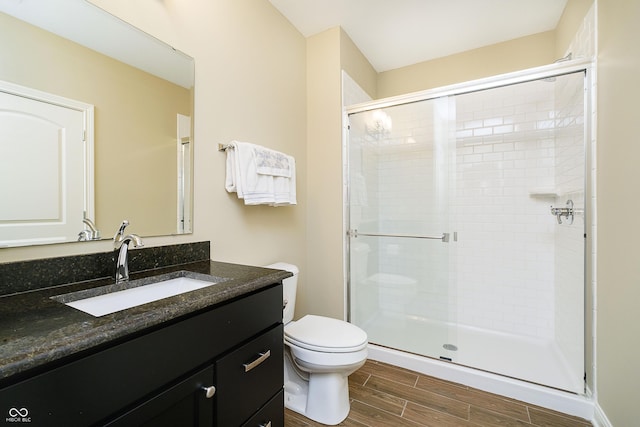 14003 Grannan Ln, Carmel, IN 46074 - bathroom featuring wood finished floors, a stall shower, toilet, and vanity