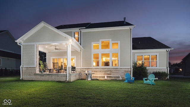 14003 Grannan Ln, Carmel, IN 46074 - back of property featuring a ceiling fan, a lawn, and brick siding
