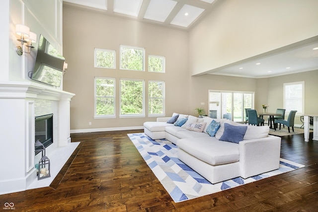 14003 Grannan Ln, Carmel, IN 46074 - living room featuring a towering ceiling, dark wood-style floors, healthy amount of natural light, recessed lighting, and a high end fireplace
