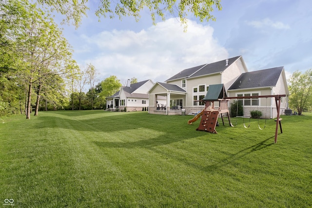 14003 Grannan Ln, Carmel, IN 46074 - back of house featuring a playground, a lawn, and central air condition unit