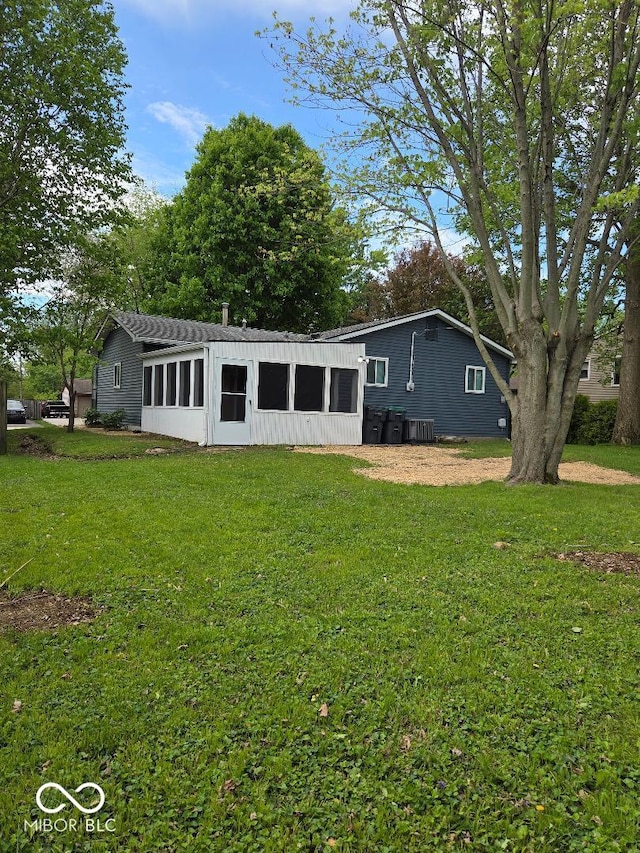706 Alexander St, Greenwood, IN 46143 - view of front facade with a sunroom and a front yard