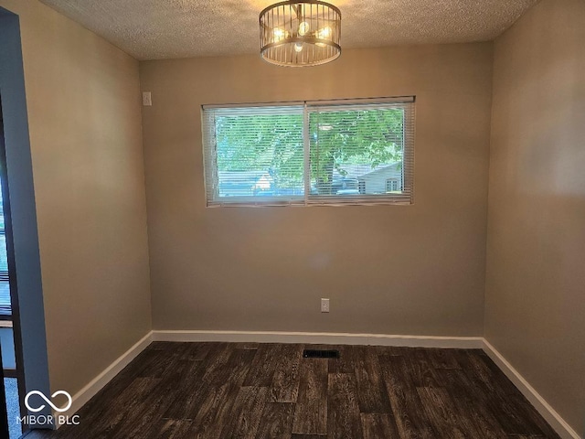 706 Alexander St, Greenwood, IN 46143 - unfurnished room with a textured ceiling, dark wood-style flooring, and baseboards