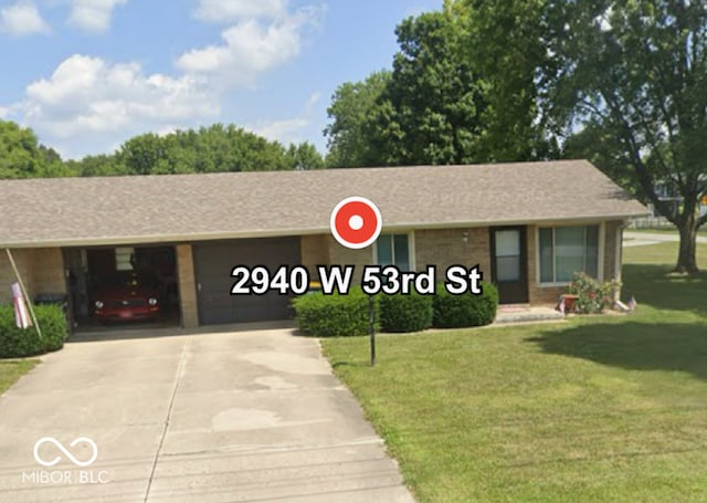 2940 W 53rd St, Anderson, IN 46011 - single story home featuring concrete driveway, an attached garage, and a front yard