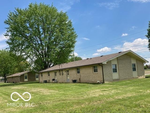 2940 W 53rd St, Anderson, IN 46011 - back of house featuring a yard and brick siding
