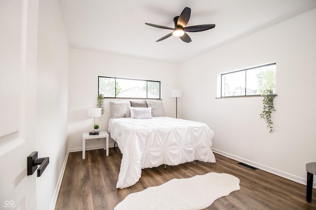 648 Market St, Hope, IN 47246 - bedroom featuring multiple windows, wood finished floors, and baseboards