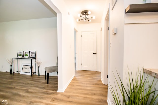 648 Market St, Hope, IN 47246 - corridor featuring a chandelier, light wood-style floors, and baseboards