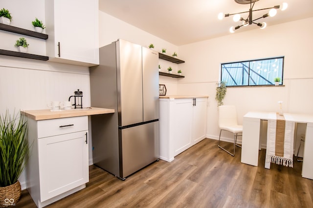 648 Market St, Hope, IN 47246 - kitchen with open shelves, freestanding refrigerator, wood finished floors, a chandelier, and white cabinets