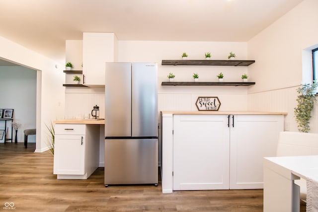 648 Market St, Hope, IN 47246 - kitchen featuring open shelves, freestanding refrigerator, white cabinets, light wood-type flooring, and wainscoting