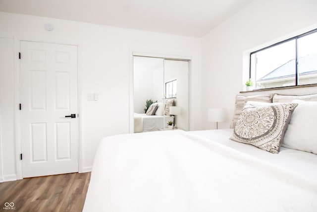 648 Market St, Hope, IN 47246 - bedroom featuring a closet, wood finished floors, and baseboards
