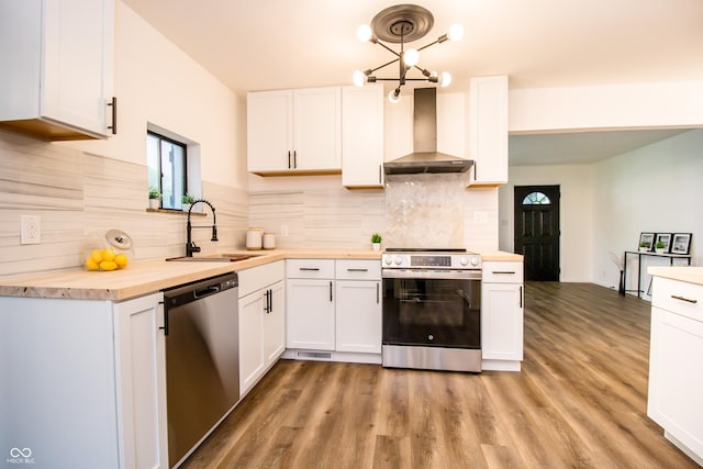 648 Market St, Hope, IN 47246 - kitchen featuring appliances with stainless steel finishes, wall chimney range hood, a sink, butcher block countertops, and white cabinets