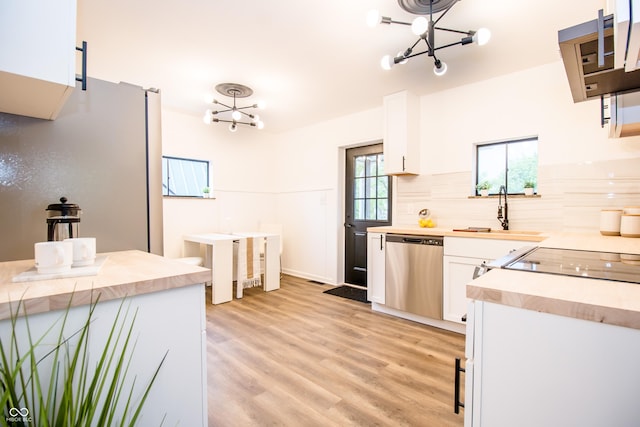 648 Market St, Hope, IN 47246 - kitchen featuring stainless steel dishwasher, a sink, freestanding refrigerator, and a chandelier