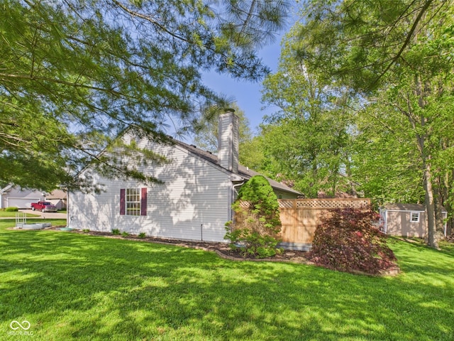 1356 S Catamaran Cir, Cicero, IN 46034 - view of side of home featuring a chimney, a shed, an outbuilding, and a yard