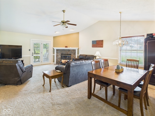 1356 S Catamaran Cir, Cicero, IN 46034 - dining area featuring light carpet, ceiling fan, lofted ceiling, a chandelier, and a tiled fireplace