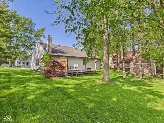 1356 S Catamaran Cir, Cicero, IN 46034 - rear view of property with a shed, a deck, a chimney, an outdoor structure, and a lawn