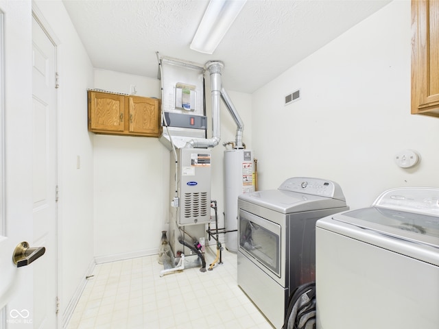 1356 S Catamaran Cir, Cicero, IN 46034 - laundry area featuring cabinet space, water heater, washing machine and clothes dryer, a textured ceiling, and light flooring