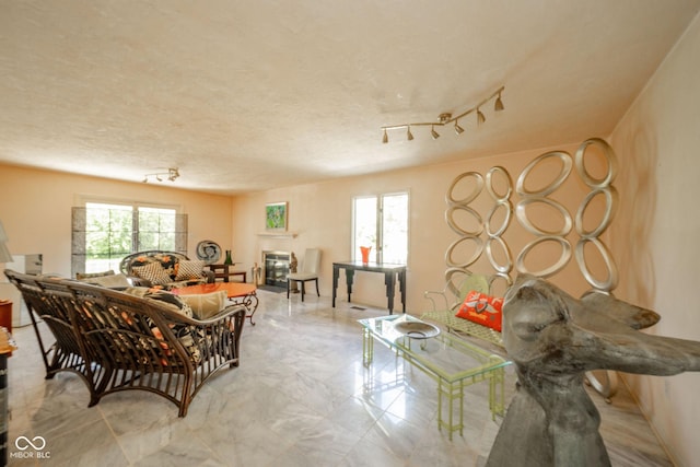 dining room with marble finish floors and rail lighting