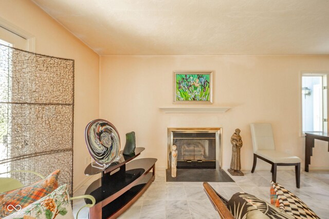 sitting room featuring a glass covered fireplace