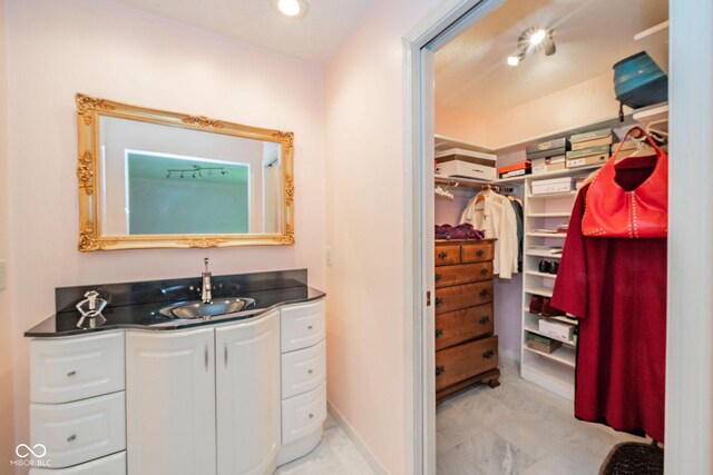 bathroom featuring vanity and a walk in closet