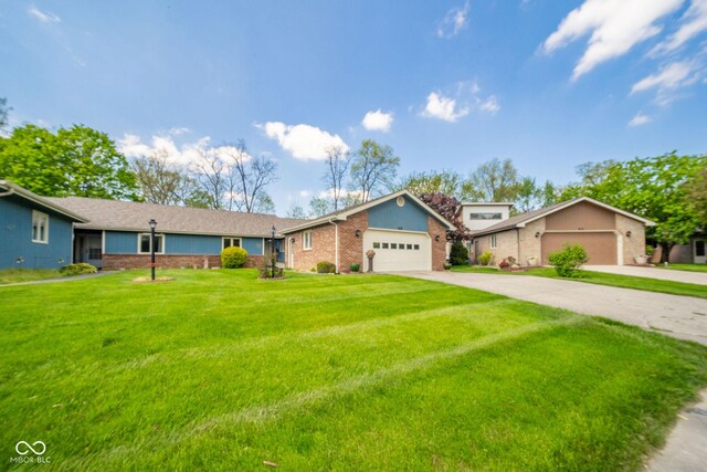 view of front facade featuring driveway, a front lawn, an attached garage, and brick siding