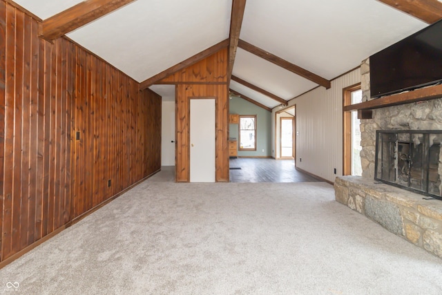 953 S 5th St, Noblesville, IN 46060 - unfurnished living room with wood walls, carpet, and a stone fireplace