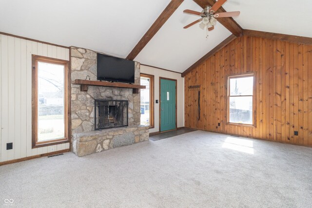 953 S 5th St, Noblesville, IN 46060 - unfurnished living room featuring plenty of natural light, a fireplace, wooden walls, ceiling fan, and carpet flooring