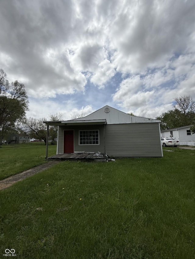 rear view of house with a lawn