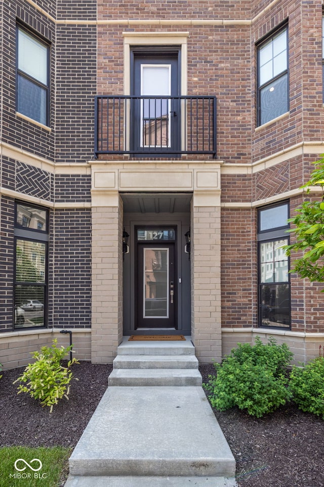 127 Monon Green Blvd, Carmel, IN 46032 - view of exterior entry featuring a balcony and brick siding