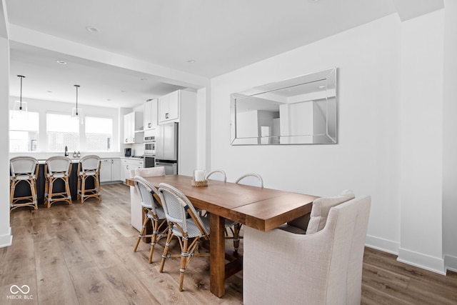 127 Monon Green Blvd, Carmel, IN 46032 - dining room featuring light wood-type flooring and recessed lighting