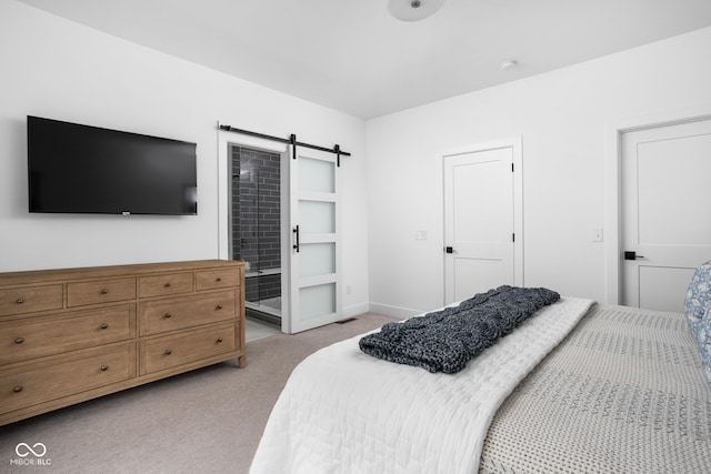 127 Monon Green Blvd, Carmel, IN 46032 - bedroom with light colored carpet, a barn door, and connected bathroom