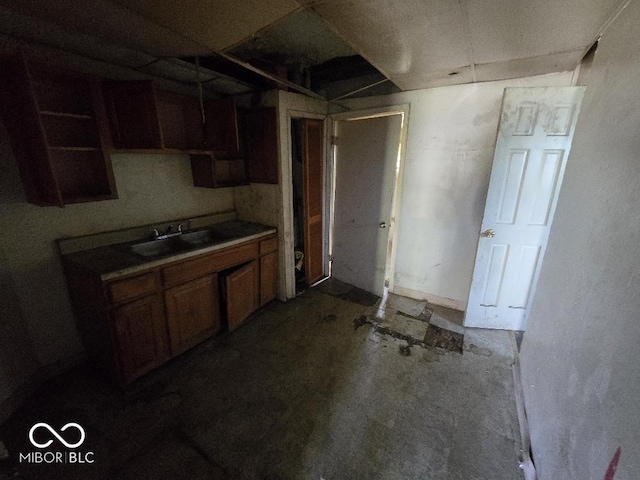 kitchen with a sink and brown cabinetry