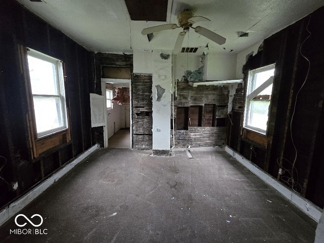 unfurnished living room with ceiling fan