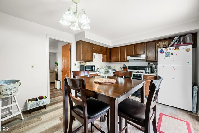 5120 Apache Ct, Columbus, IN 47203 - dining space featuring a chandelier and light wood-style flooring