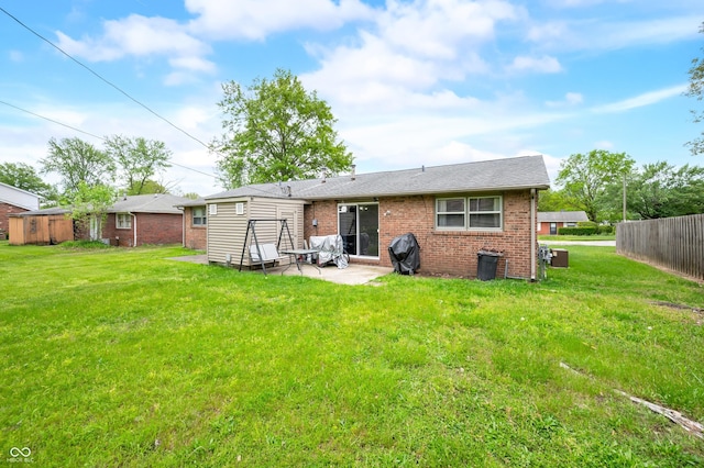 5120 Apache Ct, Columbus, IN 47203 - back of property featuring brick siding and a patio