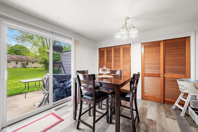 5120 Apache Ct, Columbus, IN 47203 - dining area featuring light wood finished floors and a chandelier