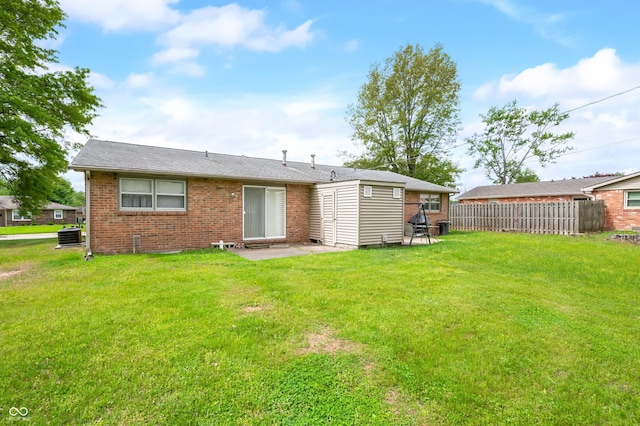 5120 Apache Ct, Columbus, IN 47203 - rear view of house with brick siding, a patio area, and central AC