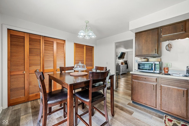 5120 Apache Ct, Columbus, IN 47203 - dining space featuring a chandelier and light wood-type flooring