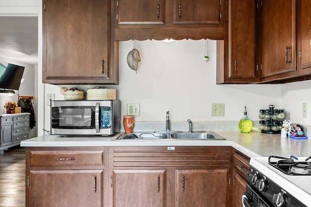 5120 Apache Ct, Columbus, IN 47203 - kitchen featuring stainless steel microwave, a sink, light countertops, and range with gas stovetop