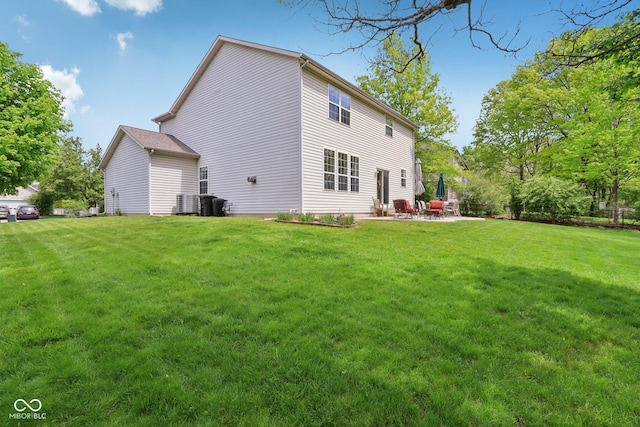 back of property with a yard and a patio area