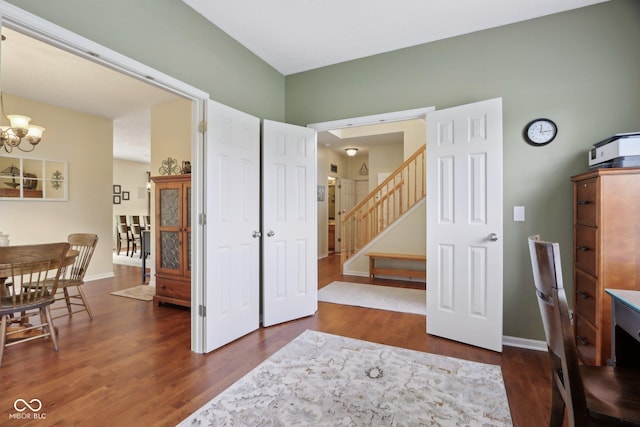office area with a chandelier, wood finished floors, and baseboards