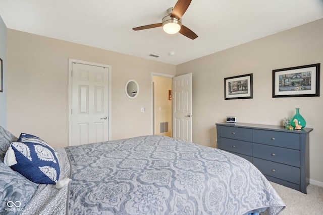 bedroom with light colored carpet, a ceiling fan, and baseboards