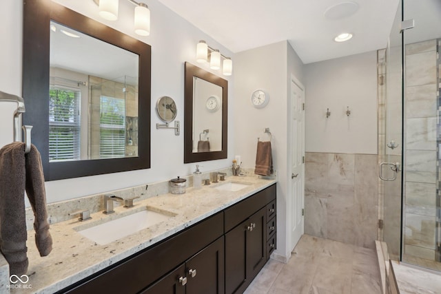 full bath with a shower stall and double vanity