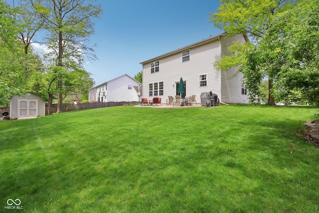 back of house featuring a patio area, a shed, and an outdoor structure