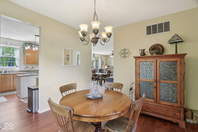 dining room featuring a chandelier and dark wood-style floors