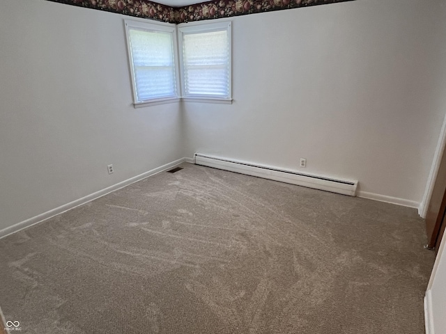 2927 E 8th St, Anderson, IN 46012 - unfurnished room with baseboard heating, carpet flooring, and baseboards