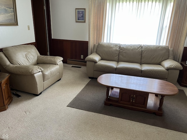 2927 E 8th St, Anderson, IN 46012 - carpeted living room featuring wainscoting and a baseboard heating unit
